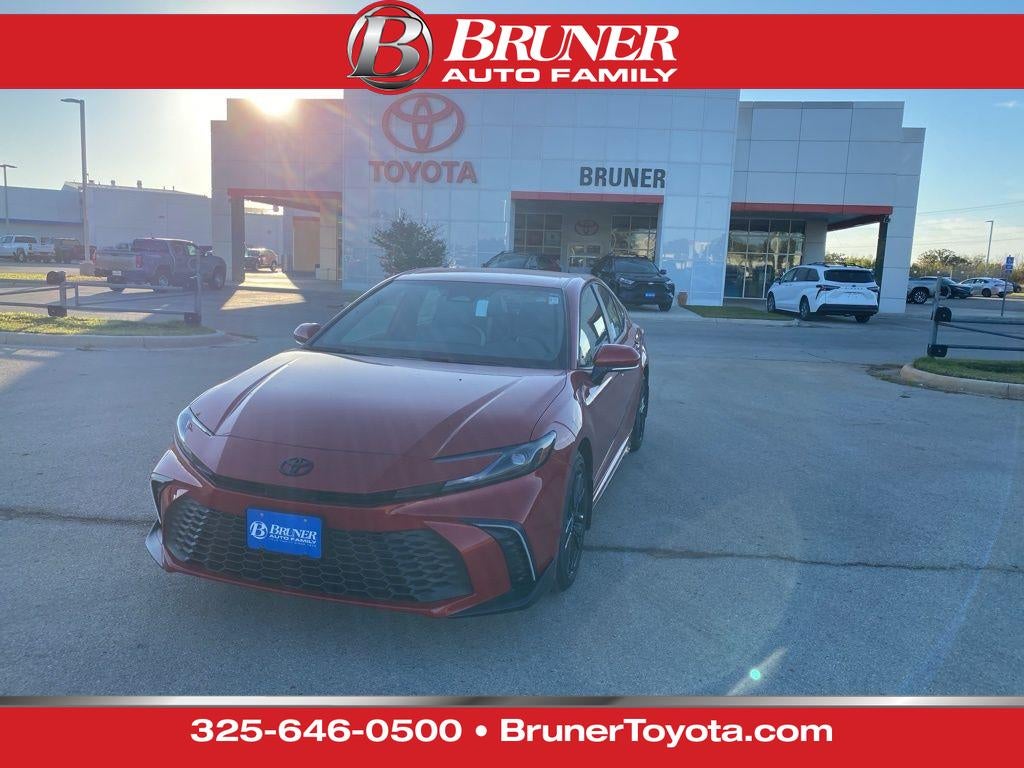 2026 Toyota Camry SE in Supersonic Red — front three-quarter view