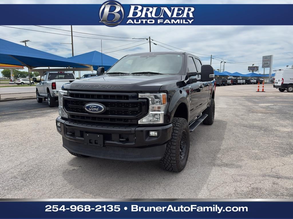 2022 Ford F-250 LARIAT in Agate Black Metallic — front three-quarter view