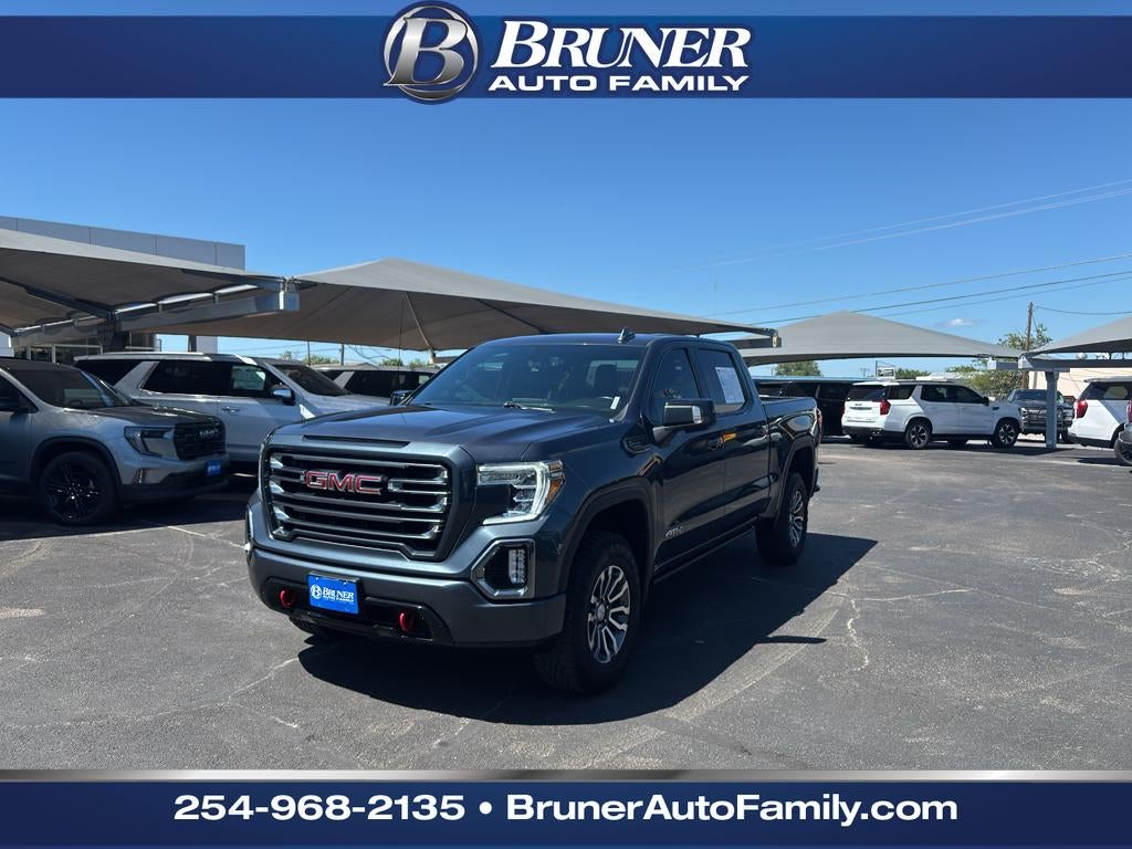 2021 GMC Sierra 1500 4WD Crew Cab Short Box AT4 in Dark Sky Metallic — front three-quarter view